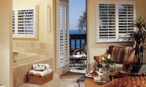 Plantation shutters on casement windows in a tropical house.
